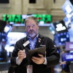 A trader works on the floor of wall street